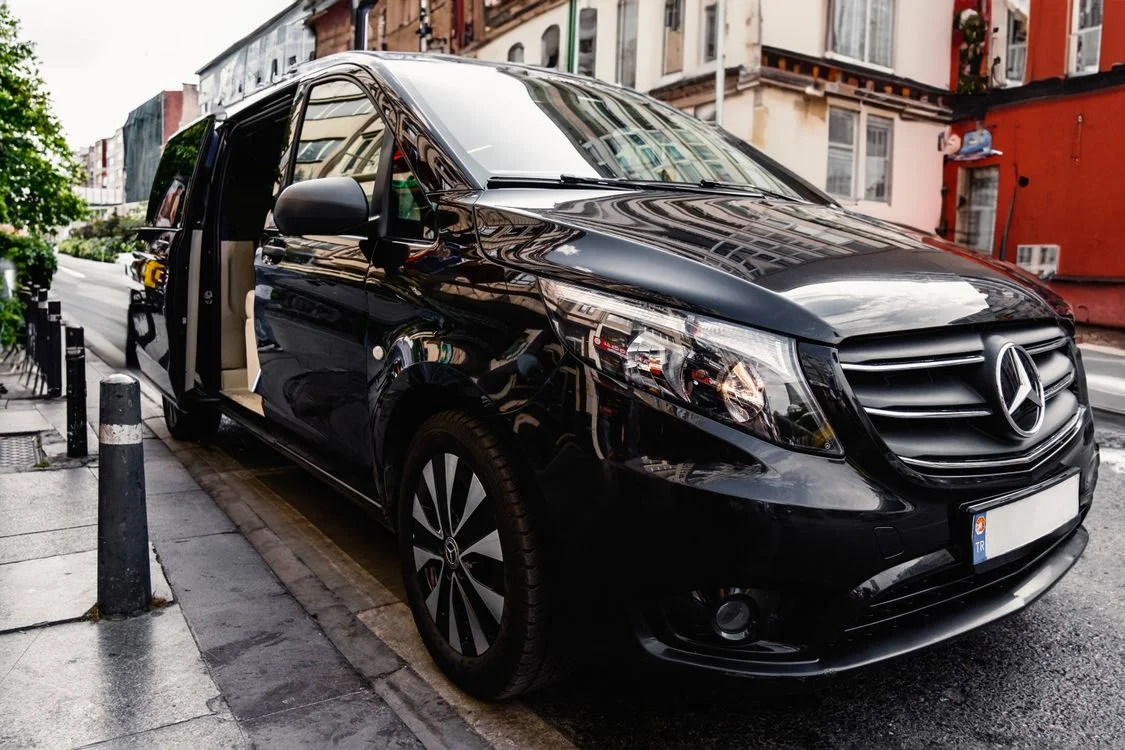 A black passenger minivan shown as transport inspiration